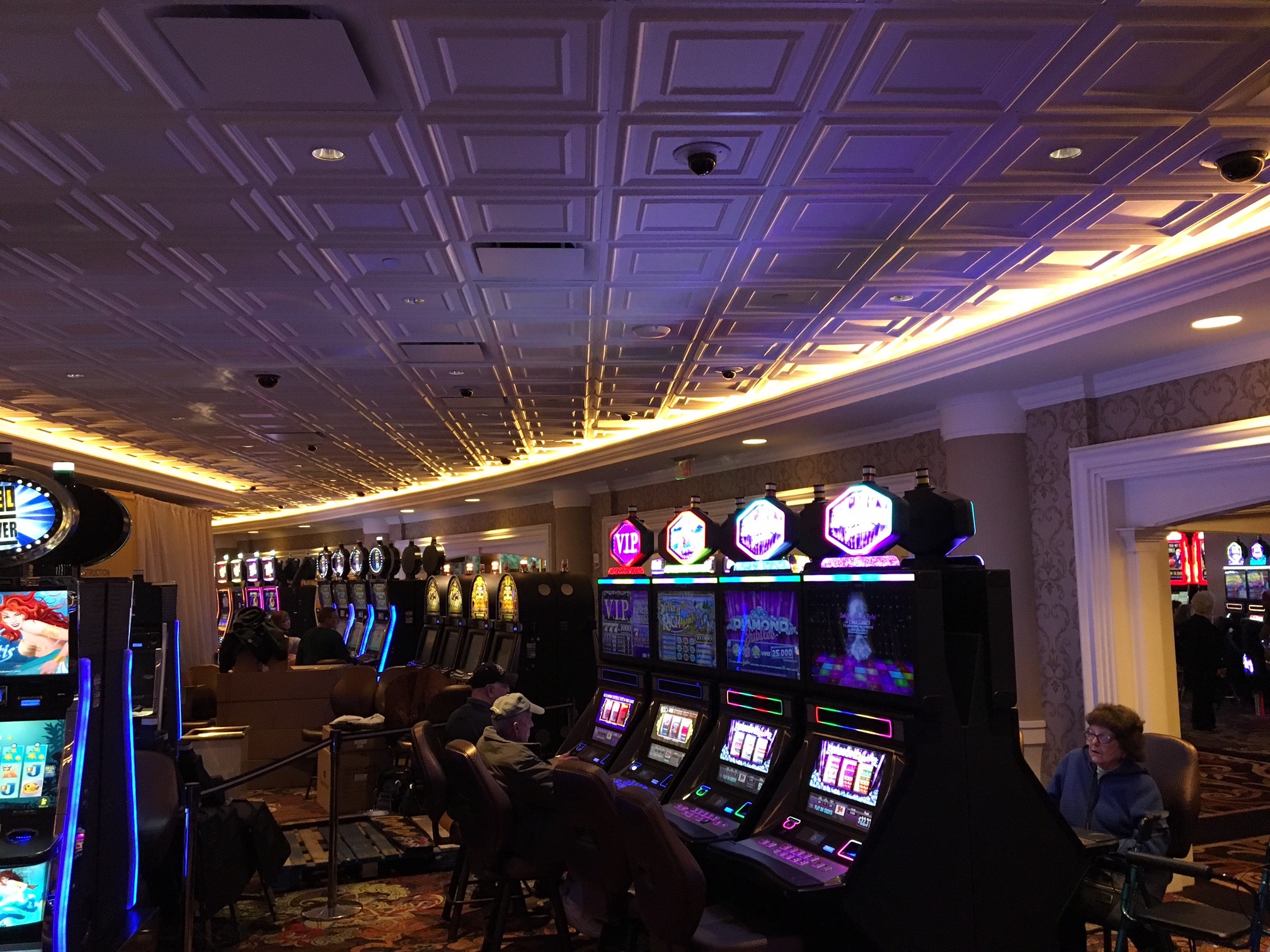 Casino with slot machines and people playing