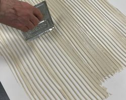 spreading glue on back of FRP panel